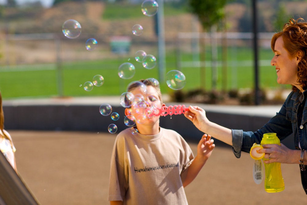 Child playing with bubbles.