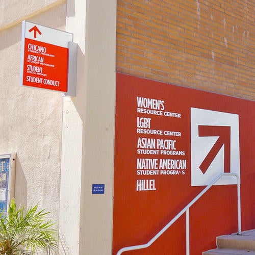 Signage of office locations on exterior of building.